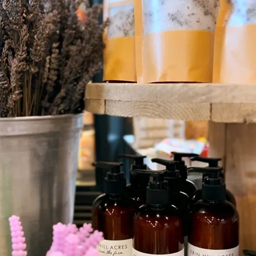 Lavender products displayed: bath salts, lotion bottles, dried lavender in metal bucket.
